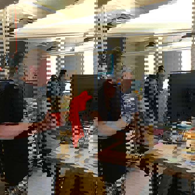 Image of Aztek employees working together on .NET code